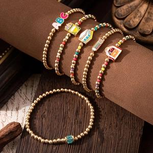 Rainbow beaded school-themed bracelet set with gold beads and colorful pencil charms