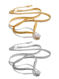 Detailed close-up of snake chain necklaces with teardrop zirconia pendants and S.Steel tags