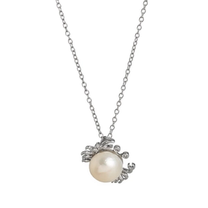 Macro shot of silver crab pendant featuring a large white pearl and zircon accents
