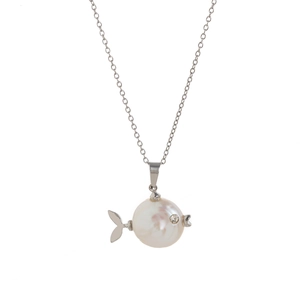 Macro detail of fish pendant with natural white pearl and sparkling crystal eye accent