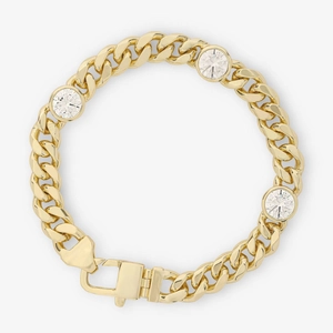 Detailed macro shot of golden cuban link bracelet with three round cut zircon stones