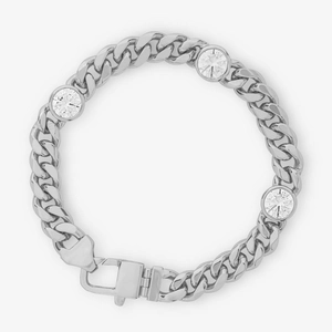 Macro detail of silver Cuban link bracelet with three round cubic zirconia stones