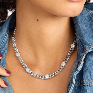 Detail of silver curb chain necklace with five circular sparkling zircon stones