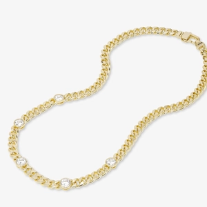 Detail of gold-plated curb chain necklace featuring five inlaid round zircon crystals