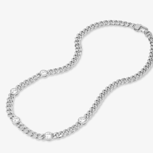 Close-up of a silver Cuban chain necklace with sparkling round zircon stones
