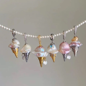 Detail of creative baroque pearl ice cream charms hanging on a luxury pearl necklace