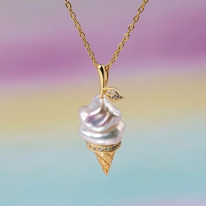 Detail of baroque pearl ice cream cone pendant with sparkling zircon inlays and gold chain