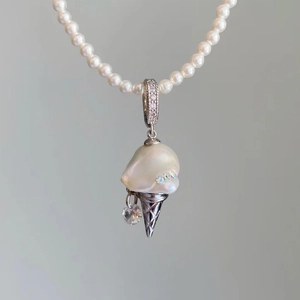 Detail of baroque pearl ice cream pendant on a luxury pearl chain necklace