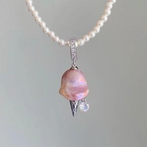 Detail of pearl necklace featuring a baroque pearl ice cream cone pendant and crystals