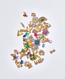Macro view of assorted 18k gold plated charms with colorful zircon and enamel details
