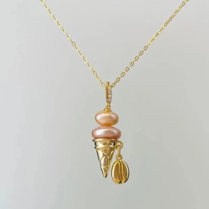 Detail of 18k gold plated ice cream cone pendant with pink pearls and coffee bean charm