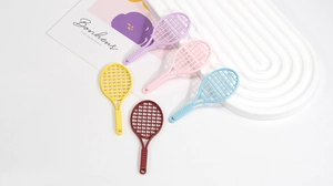 Close-up of colorful mini tennis racket pendants in five vibrant colors for DIY projects