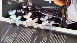 Detail of colorful bubble jelly balloon dog charms with pearl necklaces for DIY jewelry