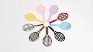 Macro shot of colorful mini tennis racket pendants in various finishes for DIY jewelry making
