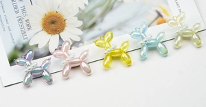Detail of colorful balloon dog charms with pearl collars and iridescent finish
