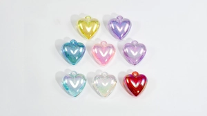 Detailed view of eight colorful frosted acrylic heart pendants for DIY accessories