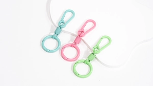 Close-up of macaron color spring snap hooks in blue pink and green for DIY keychain