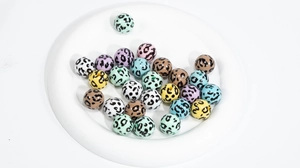 Macro shot of colorful leopard print acrylic beads for DIY jewelry and necklaces