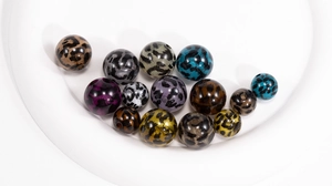 Macro shot of assorted leopard print acrylic beads for DIY jewelry and phone charms