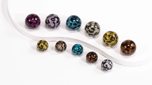 Macro shot of colorful leopard print acrylic beads for DIY jewelry and phone chains