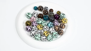 Macro shot of colorful acrylic leopard print beads with holes for DIY jewelry making