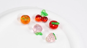 Detail of DIY fruit charms including persimmon, cherry, and strawberry for jewelry