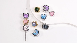 Macro view of oil painting style star and moon charms with colorful resin inlay