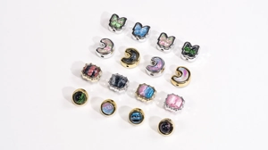 Macro shot of assorted oil painting style celestial charms with gold and silver frames