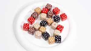 Close-up of colorful acrylic cube beads with white polka dots for DIY jewelry making