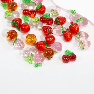 Translucent glass fruit charms including strawberry apple peach and persimmon beads