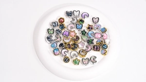 Macro shot of assorted colorful resin oil painting beads in moon star butterfly shapes