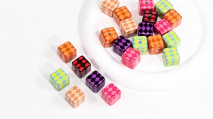 Macro shot of colorful argyle pattern acrylic cube beads for DIY jewelry and phone charms