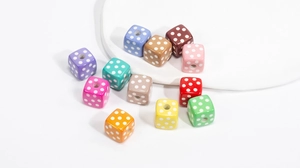 Macro detail of mixed color acrylic cube beads with white polka dots for jewelry making
