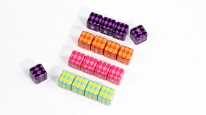 Macro view of colorful argyle pattern square beads for DIY craft jewelry making projects.