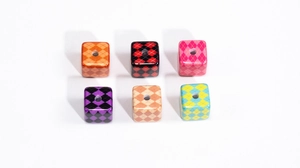 Macro detail of cube-shaped acrylic beads with diamond lattice patterns and center holes