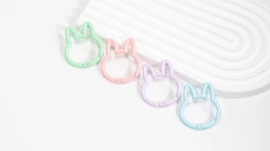 Macro detail of colorful rabbit-shaped spring buckles in pastel mint pink and purple colors