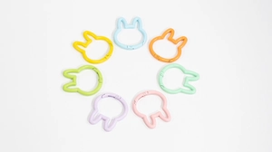 Macro shot of 7 colorful bunny rabbit head shaped spring ring carabiners for DIY crafts