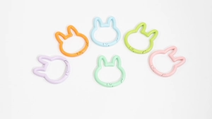 Macro view of rabbit shaped spring ring clasps in six assorted macaron colors