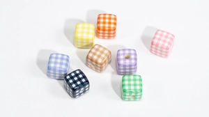 Macro shot of 8-piece assorted colorful checkerboard acrylic cube beads for DIY crafts