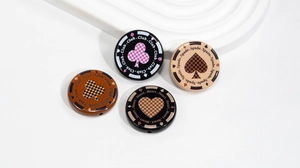 Macro view of poker chip beads with spade and heart prints for DIY jewelry making