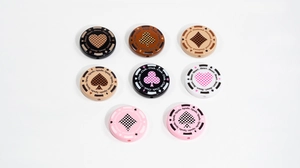 Close-up of round poker chip beads with card suits and checkerboard patterns for DIY jewelry