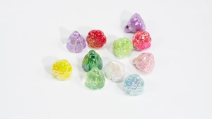 Macro shot of colorful iridescent lotus seed pod charms with holes for DIY jewelry