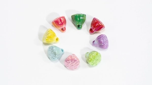 Set of eight colorful lotus seed pod charms in iridescent finishes for DIY jewelry making