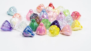 Macro shot of colorful iridescent lotus pod beads with pearl luster for DIY jewelry making