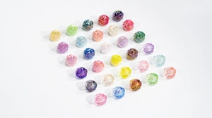Macro view of colorful iridescent lotus root beads with metallic glossy finish for DIY