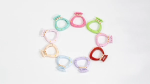 Variety of colorful lucky bag shaped metal spring buckles arranged in a circle for DIY crafts