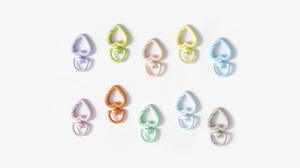 Close-up of heart-shaped spring ring alloy connectors in a variety of macaron colors