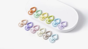Macro view of colorful heart-shaped swivel lobster clasps in matte macaron alloy finishes