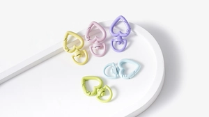 Macro detail of heart-shaped macaron metal spring rings for DIY keychains and jewelry