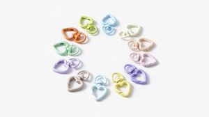 Macro view of twelve colorful heart-shaped spring clasps for DIY keychain making